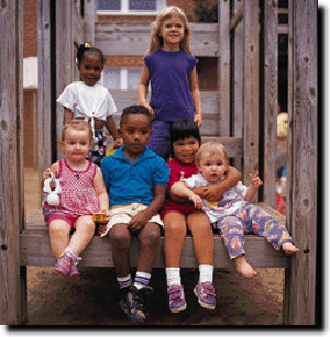 6 children all huddle together for a photo. 