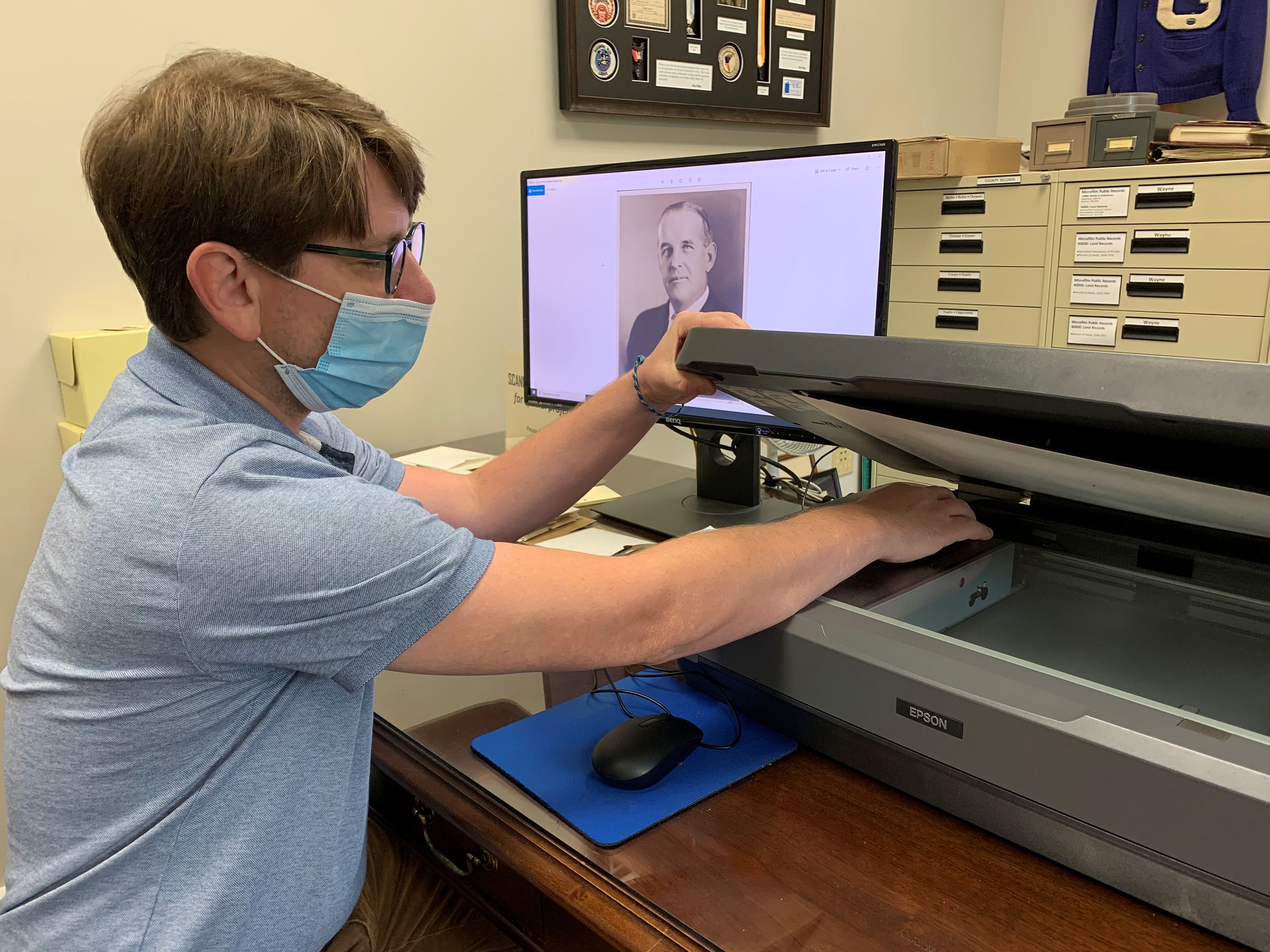 Local History Assistant, Paul Saylors, scanning photos in preparation for creating the exhibits
